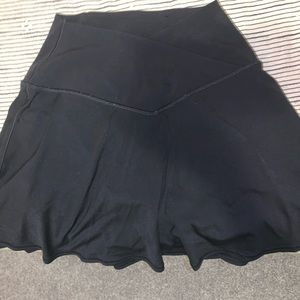 Black mini athletic skirt with shorts underneath.